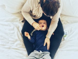 mother brushing toddlers teeth