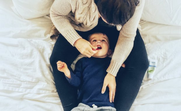 mother brushing toddlers teeth